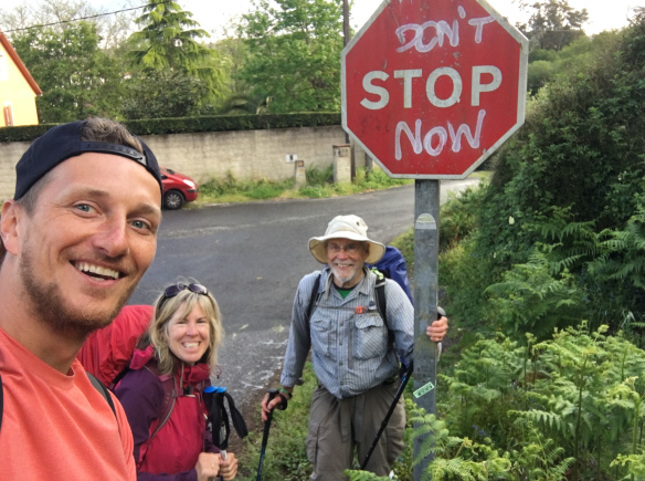 Gayle (pictured center) at the same sign I saw on my longest day of walking, from Padrón to Santiago. 